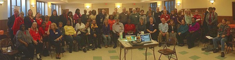 panorama photo showing attendees at event, including Bishop Johnson.