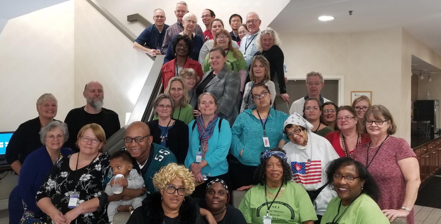 a group photo, about 35 people, including a toddler