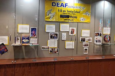 display case with banner and photos