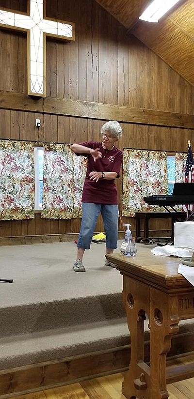 a woman on the stage signs