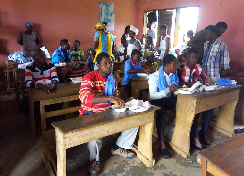 people sitting at desks in a room.