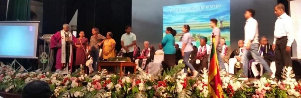 group of people on a stage making a presentation